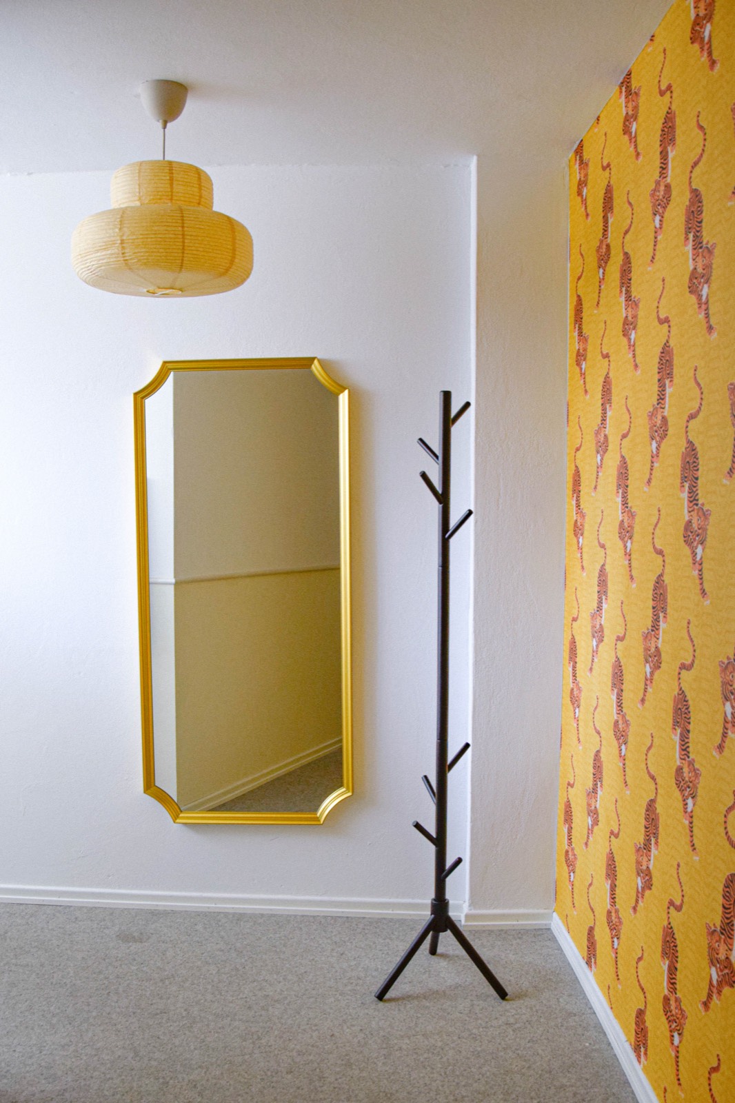 Flur mit goldenem Spiegel und Designer-Tapete